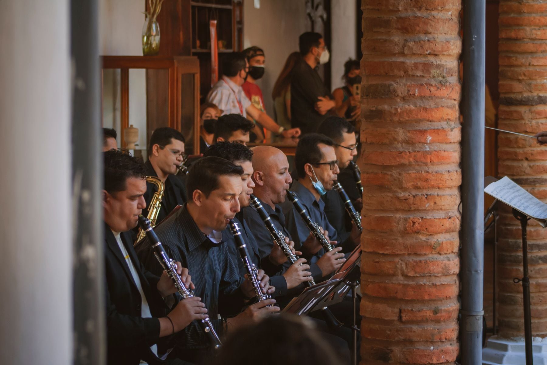 A group of musicians playing clarinets indoors.